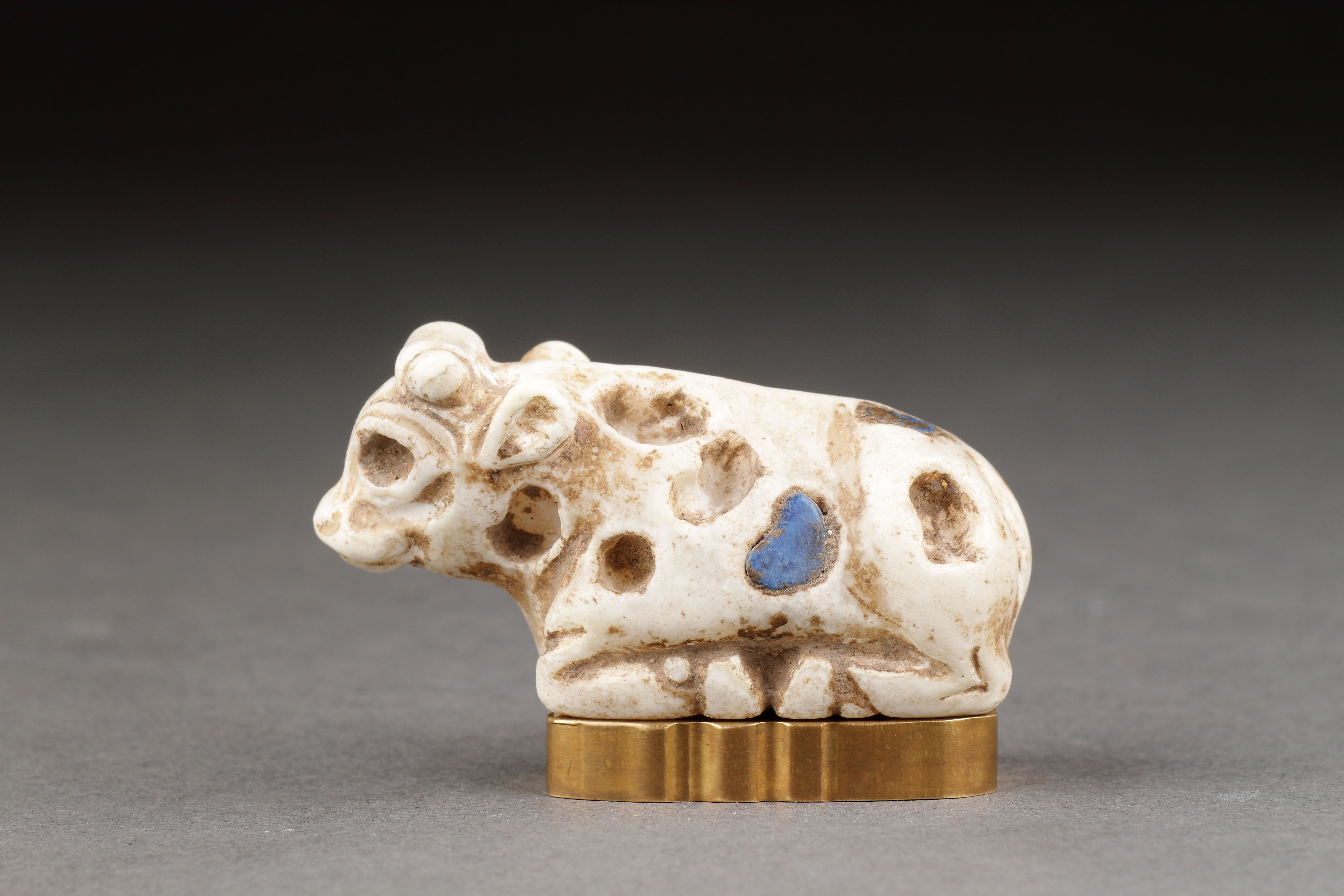 Ancient Near Eastern Sumerian Uruk White Limestone Votive Statuette of a Reclining Young Bull Inlaid with Lapis Lazuli